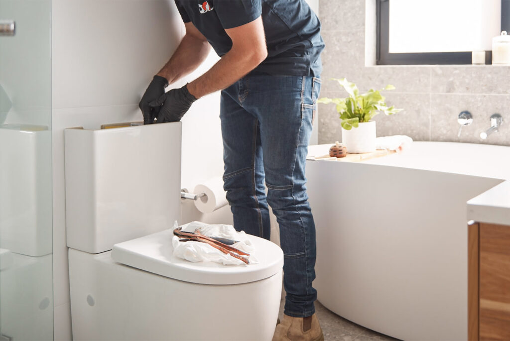 plumber repairing blocked toilet