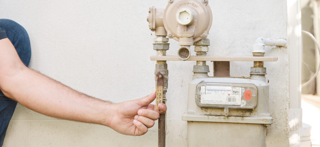 man turning off gas connection