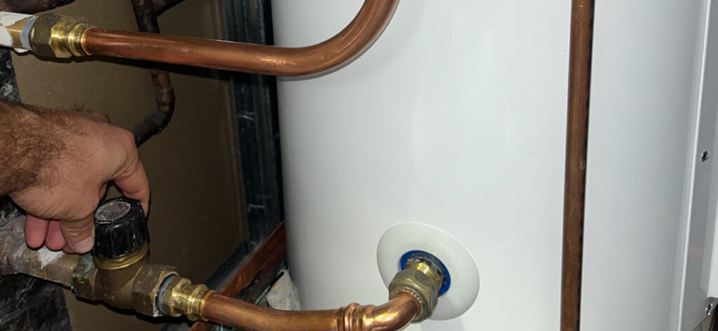 man servicing hot water system