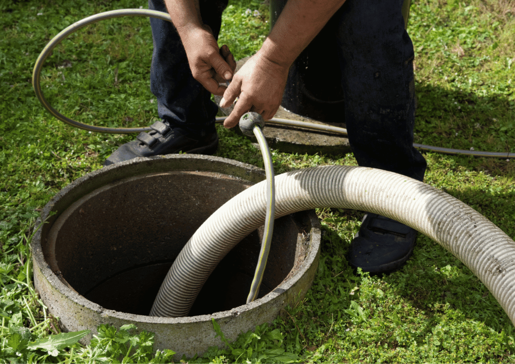 plumber putting cctv drain camera down large pipe