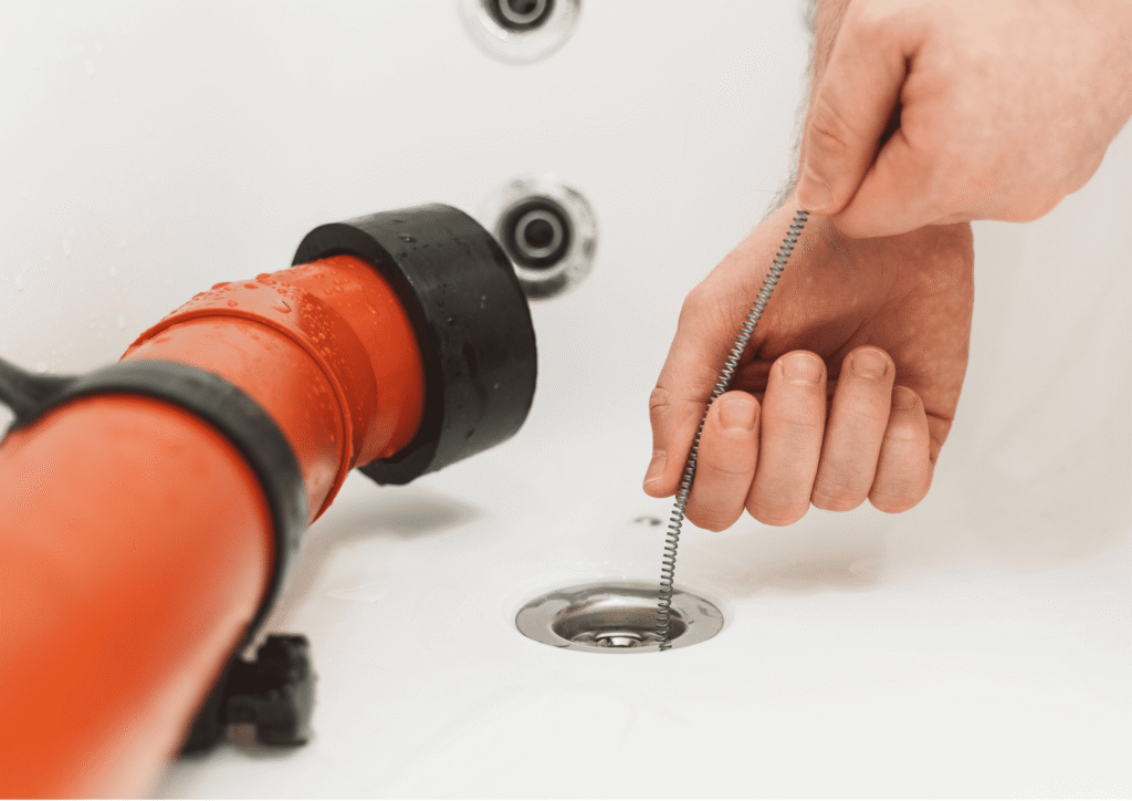 drain auger and drain snake closeup in a bathtub